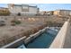 Aerial view of modern backyard with a rectangular pool, fire pit area, and contemporary landscaping at 10632 Patina Hills Ct, Las Vegas, NV 89135