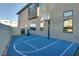 Outdoor basketball court with blue surface, white lines, adjustable hoop, and Everlast punching bag at 10632 Patina Hills Ct, Las Vegas, NV 89135