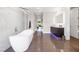 Luxurious bathroom featuring a modern soaking tub, sleek vanities, and elegant tile flooring at 10632 Patina Hills Ct, Las Vegas, NV 89135