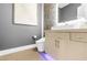 Sleek bathroom featuring a modern vanity, tiled wall, and contemporary toilet at 10632 Patina Hills Ct, Las Vegas, NV 89135