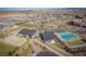 Aerial view of a pool with nearby community facilities, modern architecture, and surrounding homes at 10632 Patina Hills Ct, Las Vegas, NV 89135