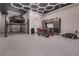 Spacious garage featuring a car lift, motorcycle parking, epoxy floors, and modern lighting at 10632 Patina Hills Ct, Las Vegas, NV 89135