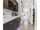 Hallway with bar area showcasing wine rack, beverage cooler, marble countertops, and hallway lighting at 10632 Patina Hills Ct, Las Vegas, NV 89135