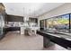 Modern kitchen with island and breakfast bar seating flows seamlessly into the outdoor living space at 10632 Patina Hills Ct, Las Vegas, NV 89135