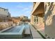 Backyard pool and spa with integrated water feature, adjacent to covered patio and outdoor dining space at 10632 Patina Hills Ct, Las Vegas, NV 89135