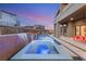 Gorgeous outdoor pool and patio featuring a spa, waterfall, and a dining area under the covered space at 10632 Patina Hills Ct, Las Vegas, NV 89135