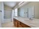 Bright bathroom with a double sink vanity, a wide mirror and a shower/tub combo at 1092 Slate Crossing Ln # 1, Henderson, NV 89002