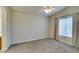 Bedroom features neutral carpet, a ceiling fan and window for natural light at 1092 Slate Crossing Ln # 1, Henderson, NV 89002