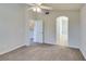 Bedroom features neutral carpet, a ceiling fan and access to an en-suite bath at 1092 Slate Crossing Ln # 1, Henderson, NV 89002