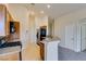 Kitchen with stainless steel appliances, breakfast bar and wood cabinets under recessed lighting at 1092 Slate Crossing Ln # 1, Henderson, NV 89002