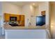 Well-lit kitchen featuring wood cabinets, a breakfast bar, and modern appliances at 1092 Slate Crossing Ln # 1, Henderson, NV 89002