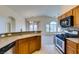 Kitchen featuring an open layout, tiled backsplash, stainless steel appliances, and a breakfast bar at 1092 Slate Crossing Ln # 1, Henderson, NV 89002