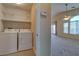 Laundry room with washer and dryer, conveniently located near living area with ceiling fan and patio access at 1092 Slate Crossing Ln # 1, Henderson, NV 89002