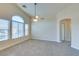 Bright living room featuring a ceiling fan, arched window and doorway to another room at 1092 Slate Crossing Ln # 1, Henderson, NV 89002