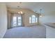 Spacious living room featuring plush carpeting, neutral tones, and natural light at 1092 Slate Crossing Ln # 1, Henderson, NV 89002