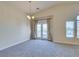 Bright living room featuring plush carpet, neutral tones, and balcony access at 1092 Slate Crossing Ln # 1, Henderson, NV 89002