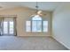 Large bright living room with a ceiling fan, and doors leading to outdoor space at 1092 Slate Crossing Ln # 1, Henderson, NV 89002