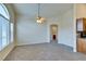 Bright living room with lots of natural light and ceiling fan, neutral colored carpet and kitchen at 1092 Slate Crossing Ln # 1, Henderson, NV 89002