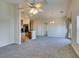 Bright living room flows into kitchen area, featuring a neutral color palette and plush carpeting at 1092 Slate Crossing Ln # 1, Henderson, NV 89002