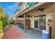 Covered back patio with brick flooring and a ceiling fan, perfect for outdoor seating and relaxation at 1209 Padre Serra Ln, Las Vegas, NV 89134