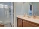 Bathroom featuring a glass door shower and a vanity with a dark wood finish and a white countertop at 1209 Padre Serra Ln, Las Vegas, NV 89134