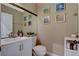 Cozy bathroom with a white vanity, framed mirror, and decorative wall art at 1209 Padre Serra Ln, Las Vegas, NV 89134