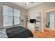 Bedroom features a window with blinds, wood floors, shelving, and closet at 1209 Padre Serra Ln, Las Vegas, NV 89134