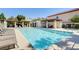 Community pool with lounge chairs and shaded seating areas for residents at 1209 Padre Serra Ln, Las Vegas, NV 89134