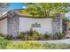 Community entrance sign featuring stone accents and lush landscaping at 1209 Padre Serra Ln, Las Vegas, NV 89134