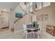 Open dining area featuring an industrial-style light fixture, staircase, and neutral walls at 1209 Padre Serra Ln, Las Vegas, NV 89134