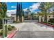 Community entrance gate with lush landscaping and secure access for residents at 1209 Padre Serra Ln, Las Vegas, NV 89134