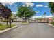 Community entrance gate with mature trees and landscaping at 1209 Padre Serra Ln, Las Vegas, NV 89134