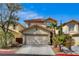 Charming two-story home featuring desert landscaping and an attached two-car garage at 1209 Padre Serra Ln, Las Vegas, NV 89134