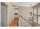 Hallway features hardwood floors, storage, and natural lighting from a window at the top of the stairs at 1209 Padre Serra Ln, Las Vegas, NV 89134