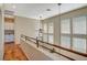 Upstairs hallway with wood floors, tall windows, and a view of the lower level at 1209 Padre Serra Ln, Las Vegas, NV 89134