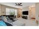 Comfortable living room featuring a large sectional sofa, tile flooring, and natural light at 1209 Padre Serra Ln, Las Vegas, NV 89134