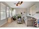 Bright living room featuring a fireplace, comfortable seating, and an adjacent office space at 1209 Padre Serra Ln, Las Vegas, NV 89134