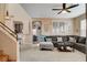 Open floorplan view from the staircase into the living room featuring a gray sectional sofa at 1209 Padre Serra Ln, Las Vegas, NV 89134