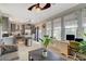 Open floorplan living room with neutral walls, gray kitchen and an abundance of natural light at 1209 Padre Serra Ln, Las Vegas, NV 89134