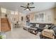 Bright living room featuring a large sofa, tile flooring, and dining area at 1209 Padre Serra Ln, Las Vegas, NV 89134