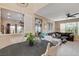 Open floorplan with a view from the dining area into the kitchen and living room with a dark gray sofa at 1209 Padre Serra Ln, Las Vegas, NV 89134