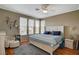 Bright main bedroom features a ceiling fan, wood floors, and a bay window that provides natural light at 1209 Padre Serra Ln, Las Vegas, NV 89134