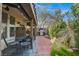 Outdoor patio featuring brick flooring, seating area, and outdoor kitchen with grill; perfect for entertaining at 1209 Padre Serra Ln, Las Vegas, NV 89134