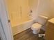 This bathroom features a shower-tub combo, toilet, and vanity with light wood cabinet storage at 1401 N Michael Way # 239, Las Vegas, NV 89108