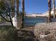 View of the Manetta Lane community sign surrounded by trees and bushes on a bright day at 1401 N Michael Way # 239, Las Vegas, NV 89108