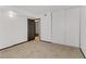 Neutral carpeted bedroom featuring a view of a secondary room and sliding closet doors for storage at 1405 Vegas Valley Dr # 286, Las Vegas, NV 89169