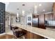 Modern kitchen featuring a granite breakfast bar with dark wood cabinetry and stainless steel appliances at 150 Las Vegas Blvd # 1608, Las Vegas, NV 89101