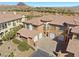 Aerial view of home with three-car garage, tile roof, and landscaped yard at 16 Via Visione # 101, Henderson, NV 89011