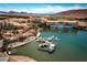 A stunning aerial view of a resort community on a beautiful lake with boats docked at 16 Via Visione # 101, Henderson, NV 89011