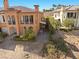 Home exterior with patio, balconies and verdant landscaping at 16 Via Visione # 101, Henderson, NV 89011